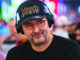 Phil Hellmuth, the legendary poker champion with multiple WSOP bracelets, sitting at a poker table with a focused expression, preparing to make a move