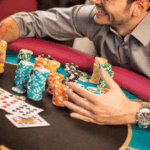 "Stack of poker chips and cash on a poker table representing buy-ins for cash poker and bankroll management."