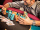 "Stack of poker chips and cash on a poker table representing buy-ins for cash poker and bankroll management."