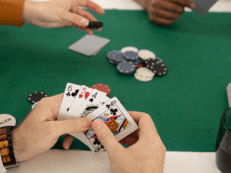 "People playing poker at a table, focusing on cards and chips"